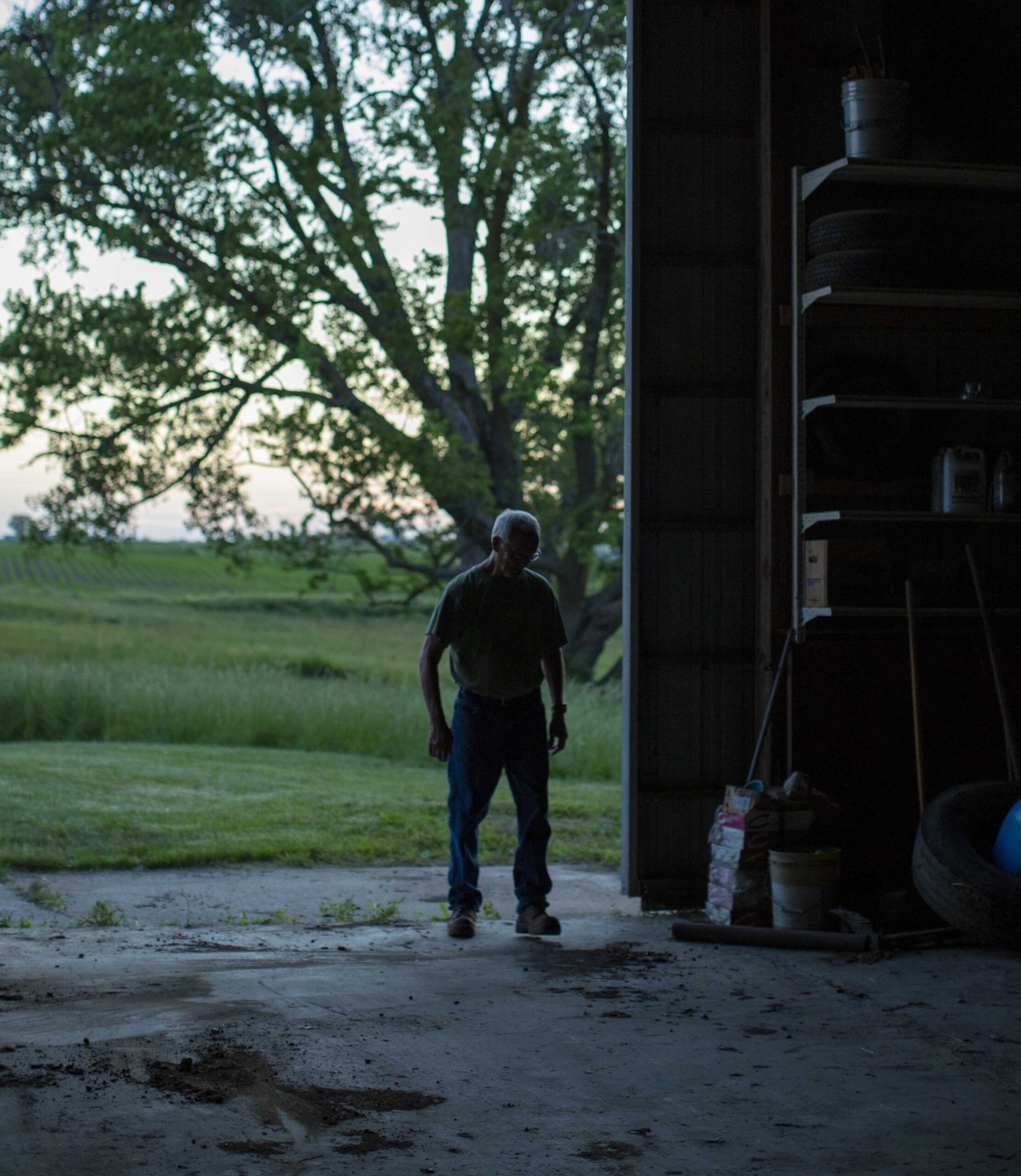 Farmer walking into his machine shed